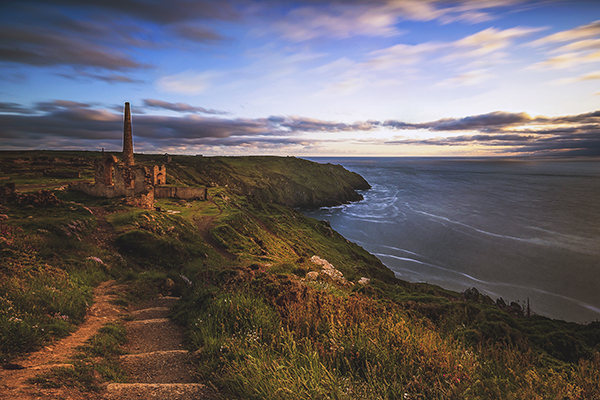 One of the filming locations of Poldark, a view of a walk in Cornwall leading to a ruin along a coastal path.